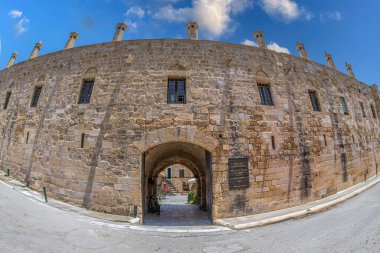 NICOSIA, CYPRUS - JUNE 18, 2024: Buyuk Han, the largest caravansarai on the island. It was built by the Ottomans in 1572. In courtyard is a mosque with a fountain courtyard cafes and souvenir shops. clipart