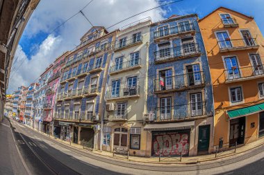 LISBON, PORTUGAL - APRIL 7, 2024: Multicolored houses on Rua da Boavista, a street located in the Cais do Sodre neighborhood. It was ranked among the top 10 coolest streets in the world by Time Out. clipart