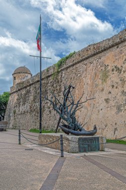 ALGHERO, İtalya - 3 Temmuz 2024: Forte della Maddalena yakınlarındaki sanat eseri, geleneksel ve çağdaş unsurlarla kentin tarihsel sürekliliğinin sembolü olan modern bir heykel