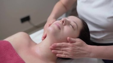 Relaxing facial massage of a beautiful young girl. High quality 4k footage