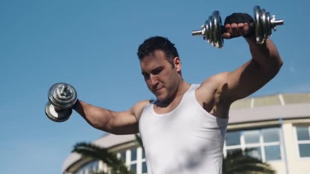 Athlete Beautiful Body Large Muscles Raises His Hands Dumbbells Nature — Vídeo de stock
