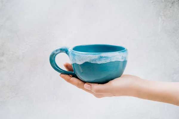 Large tea cup in hand. High quality photo