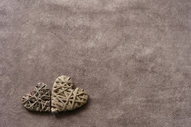 two wooden heart on a textured brown background. Dark tone. Inscription, text valentine's day