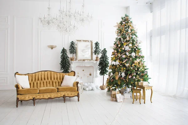 large white living room with a vintage grey sofa and a large Christmas tree with gifts and panoramic window