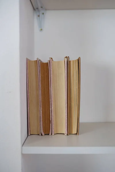 old vintage book on light shelf vertical placement