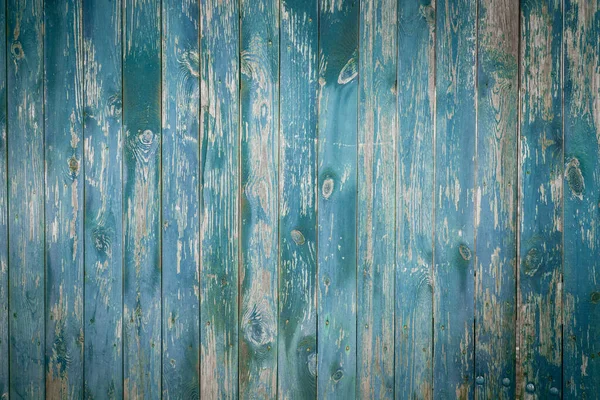 stock image Old wooden fence, boards, firewood, blue wall. Rural background