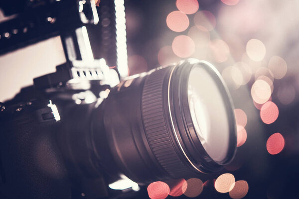 Closeup of Professional Camera Lens with Bokeh Background. Photographic Equipment Theme.