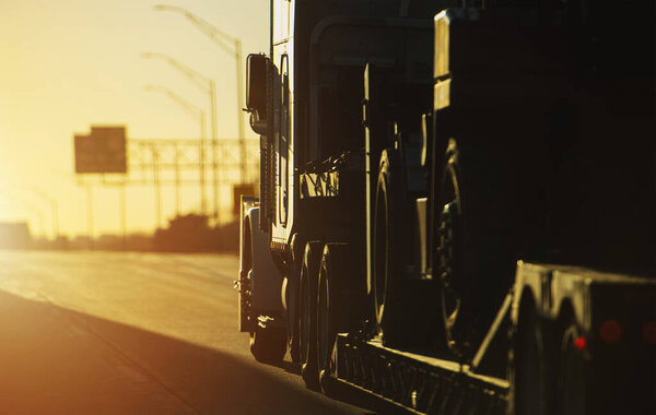 Heavy Duty Semi Truck Trailer Transportation. American Highway Sunset Scenery.