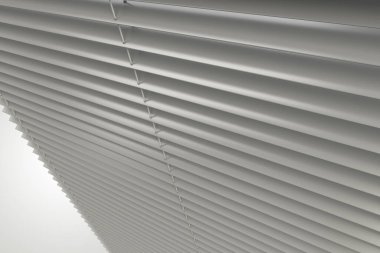 Horizontal Slats Classic White Plastic WIndow Blinds 3D Rendered Illustration. Residential and Commercial Window Covers