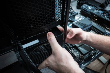 Powerful Modern Desktop Computer Workstation Building by Caucasian Technician. 