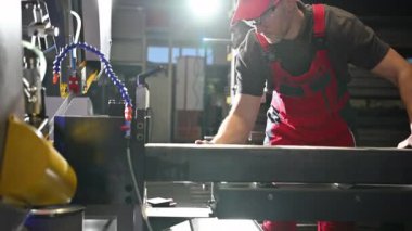 Metal Cutter Operator Cutting Piece of Square Tube