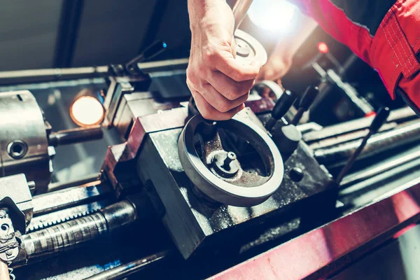 Stock image Lathe Machine Technician Processing a Piece of Metal. Metalworking Industry Theme.