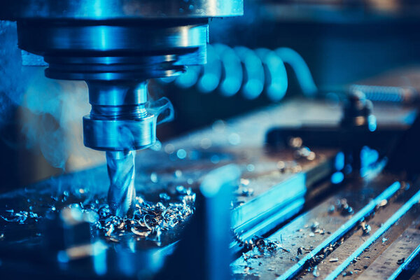 CNC Milling Machine During Operation. Nozzle Part Closeup. Production Technology and Manufacturing Equipment Theme.