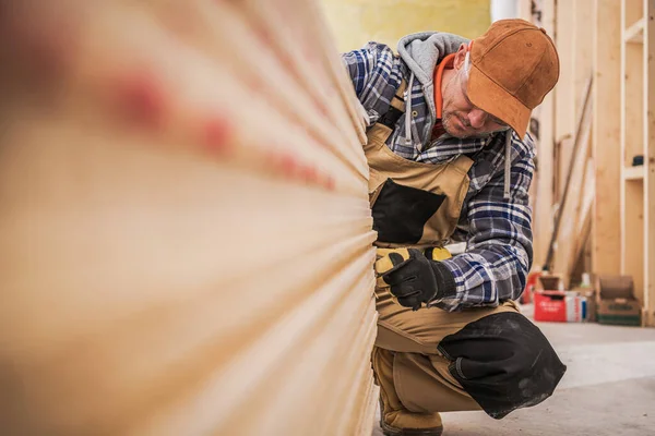 Caucasian General Construction Contractor Worker in His 40s Counting Pieces of Drywall Boards