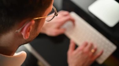 Caucasian Man Working on His Desktop Computer in His Office