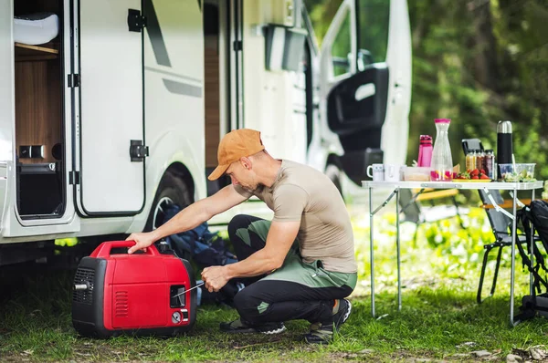 stock image Experienced RV Traveler Starting the Power Generator by His Motorhome While Setting Up for a Stay at Camping Spot.