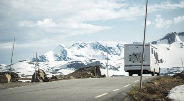 Modern Camper Van on a Scenic Norwegian Mountain Route. Scandinavian Scenery. clipart