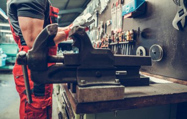 Bir araba tamirhanesinde yaşlanmış ahlak masası. Arka planda Kafkasyalı Tamirci.