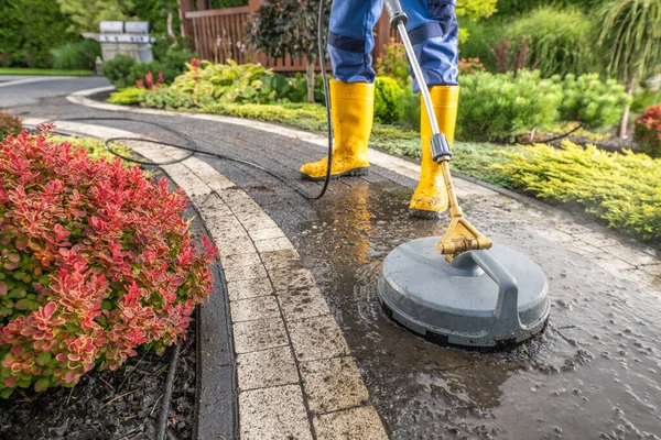 stock image Garden Worker Pressure Washing Decorative Bricks Garden Paths. Garden Keeper Job.