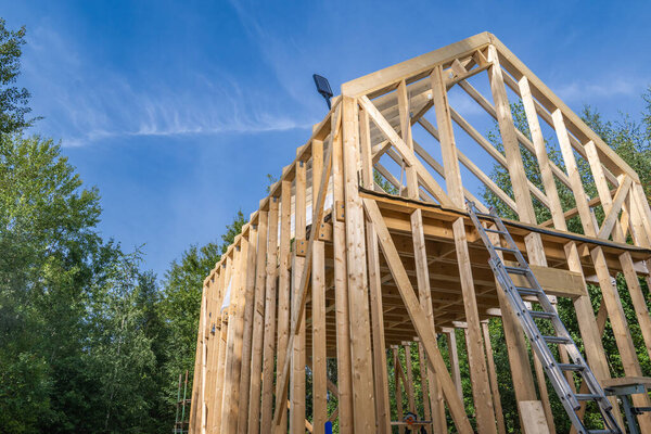 Newly Built Wooden House Skeleton Frame. Carpentry Industry Theme