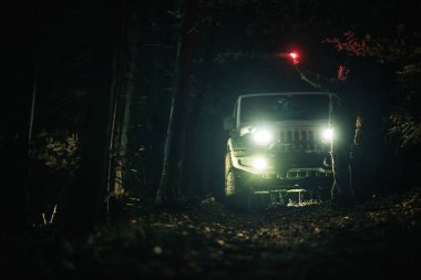 4x4 AWD Muddy Woodland Yolu 'ndaki Gece Saati Aracı. Keşif Teması.