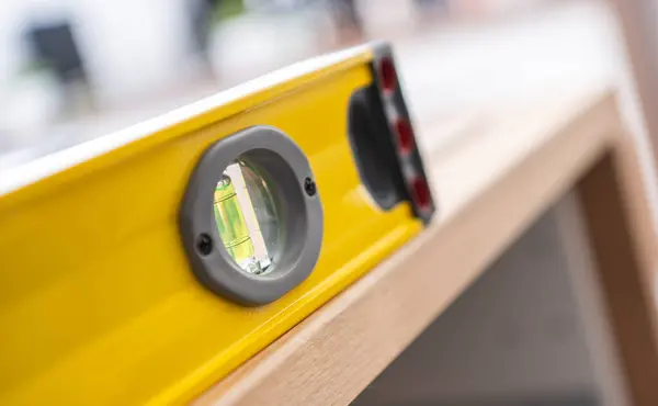 Yellow Professional Spirit Level Wooden Counter Top Furniture Assembly Theme — Stock Photo, Image