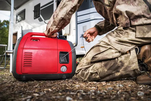 Camper Owner Firing Portable Electricity Generator While Camping Stock Image