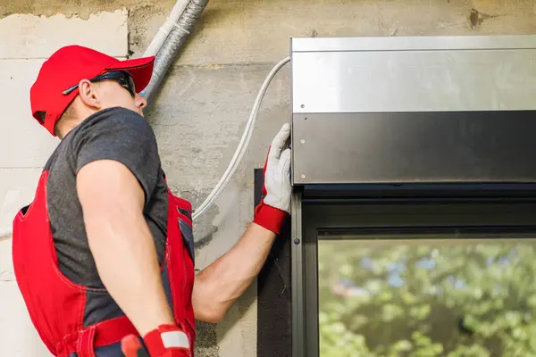 Professional Caucasian Technician Installing Automatic Outdoor Window Shutters Stock Image