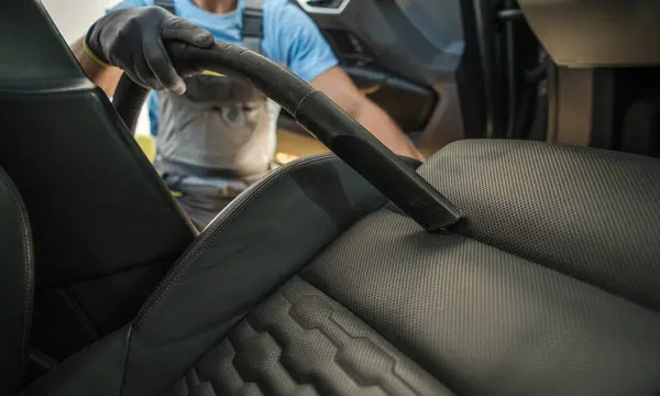 Man Vacuuming Modern Vehicle Seats Close Automotive Theme รูปภาพสต็อกที่ปลอดค่าลิขสิทธิ์