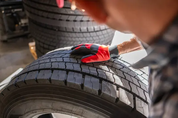 Worker Focused Fixing Truck Tire Mechanics Garage Стоковое Изображение
