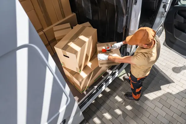 Courier Loading Cardboard Boxes White Cargo Delivery Van Стоковая Картинка