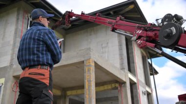 İnşaat İşçisi, Pencere Turna Operasyonunu Gündüzleri Yeni Bir Mahallede Çerçevelemek İçin Denetliyor