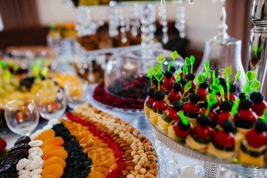 assorted snacks on the board with sauses on wooden table