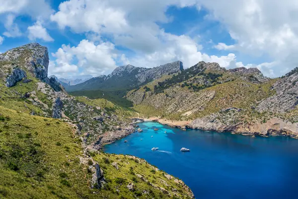 Experience the wild beauty of Cap de Formentor, Mallorca, with its soaring cliffs, historic lighthouse, and Cala Figuera\'s tranquil waters.