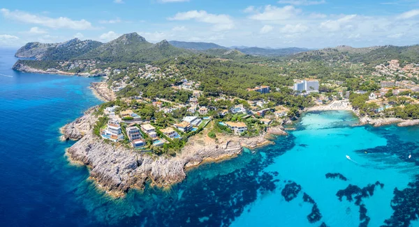 Aerial view with serene Cala N Aladern and family-friendly Sa Font de Sa Cala, nestled on Mallorca\'s untouched eastern coast.