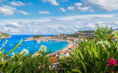 Port de Soller: a stunning snapshot where the UNESCO-protected Tramuntana Mountains meet the tranquil, azure waters of Mallorca's west coast. clipart