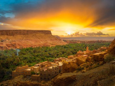 Experience the stunning sunset over a Berber village in Dades Valley, Tinghir, Morocco. This scenic view of Todra Gorge captures the essence of traditional rural life. clipart