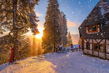 Sunset at Postavaru Chalet in Poiana Brasov in winter season. Perfect for winter getaways, skiing, and exploring Romania Carpathian Mountains. clipart