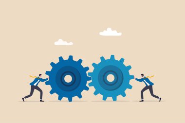 Teamwork and cooperation in a business setting, idea that working together can lead to success, collaboration or synergy concept, businessman push gear cogwheels together leading to success.