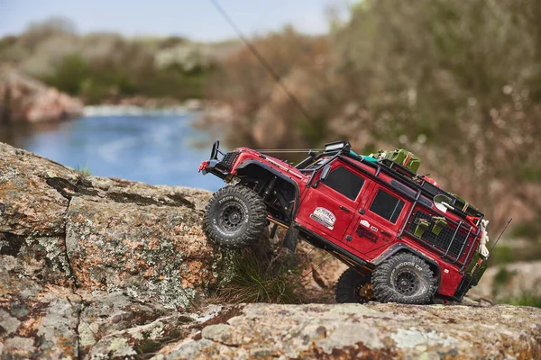 stock image RC Car. Model Land Rover Defender 1:10. Machine trophy. Camel Trophy. A radio-controlled model stands on the rocks. radio controlled car.