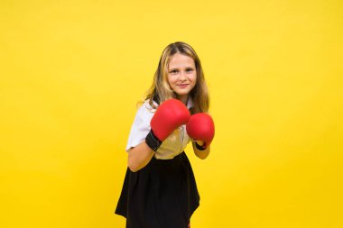 Adorable little girl boxer practicing punches in a studio
