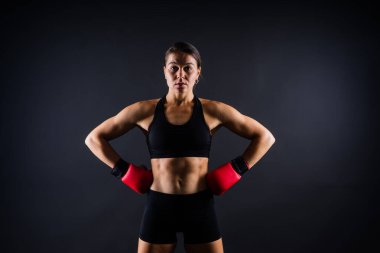 Woman Boxer In Gloves Training On a black, red, yellow Background