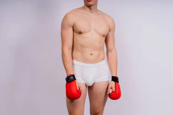 白色背景和白色裤子运动型健美运动员拳击手套 — 图库照片