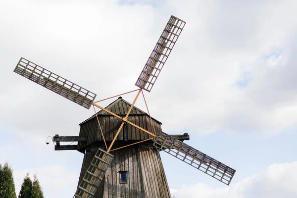 Old wooden wind mill in on sunny day. Old traditional Dutch mill.