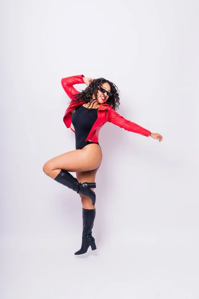 stock image Sensual beautiful african ethnic woman in bodysuit posing in studio isolated red white background