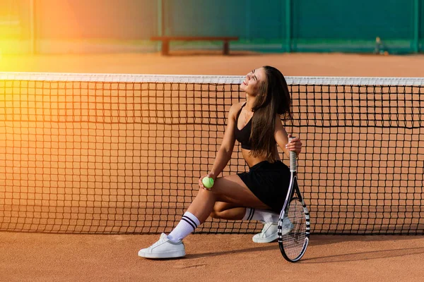 Tenis kortunda güzel bir kadın. Siyah Moda Giyen Seksi Kızın Portresi Spor Giyim Salonu 'nda tenis raketi tutuyor.