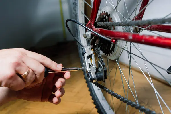 Serviceman repairing bicycle tire with tools, close up photo