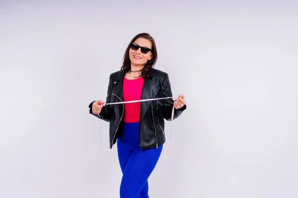 stock image Overweight woman measuring waist before weight loss in a studio shot on yellow background