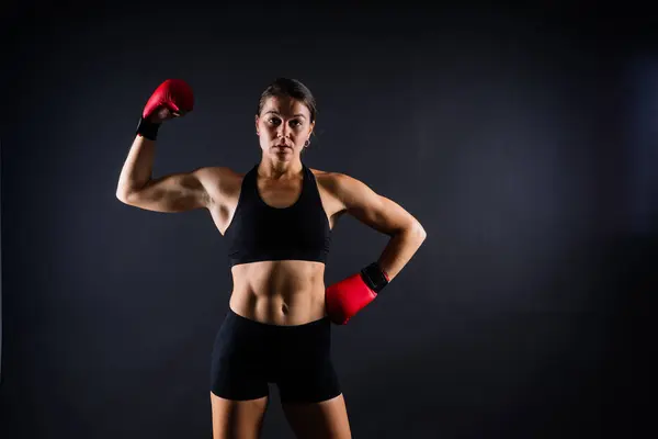 MMA female in a sports uniform ready to fight, defense of women from violence