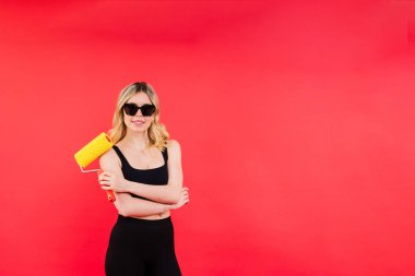 Heyecanlı bir bayan müteahhit. Boyama fırçası veya boya silindirli bir ressam.